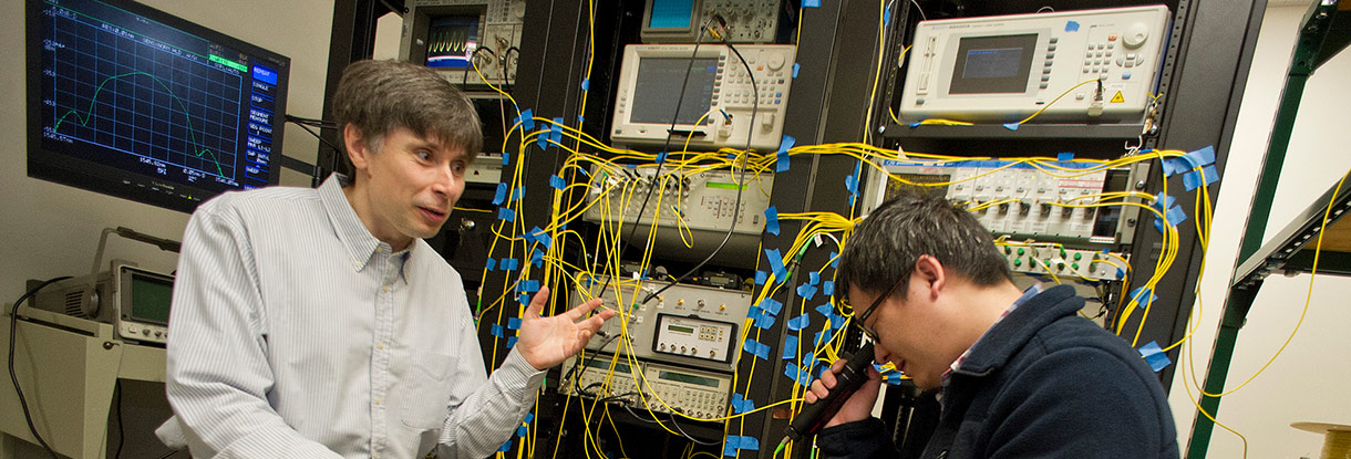 two men infront of electronic equipment