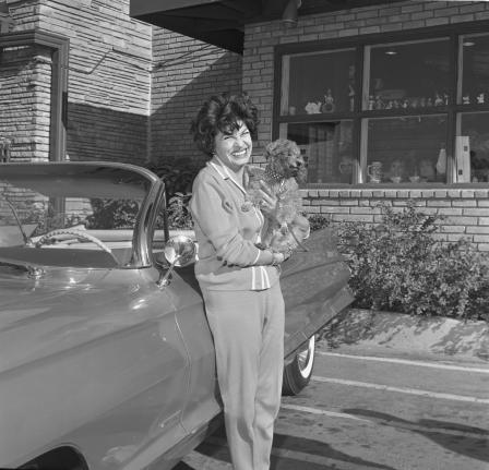 Martha Ray and poodle Conkie in Solid gold Cadillac at Casa Manana in 1961