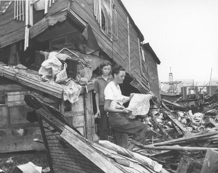  1949 flood - mother and daughter in front of wrecked home