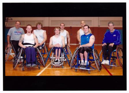 University of Texas at Arlington President James Spaniolo in wheelchair with Movin' Mavs wheelchair basketball team, 2006.