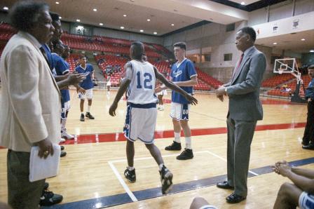 Dunbar High School basketball coaches Robert Hughes and Leondas Rambo with team