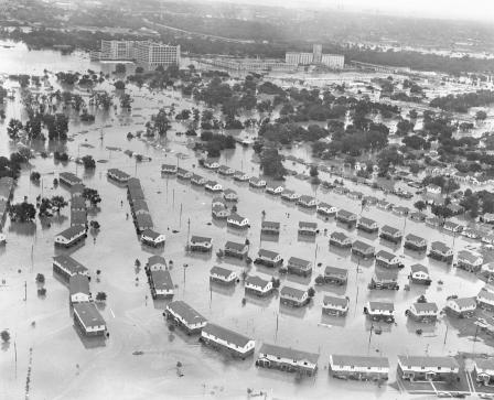 Fort Worth flood of 1949 showing homes and apartment buildings flooded. The large Montgomery Ward building in the upper center received extensive damage