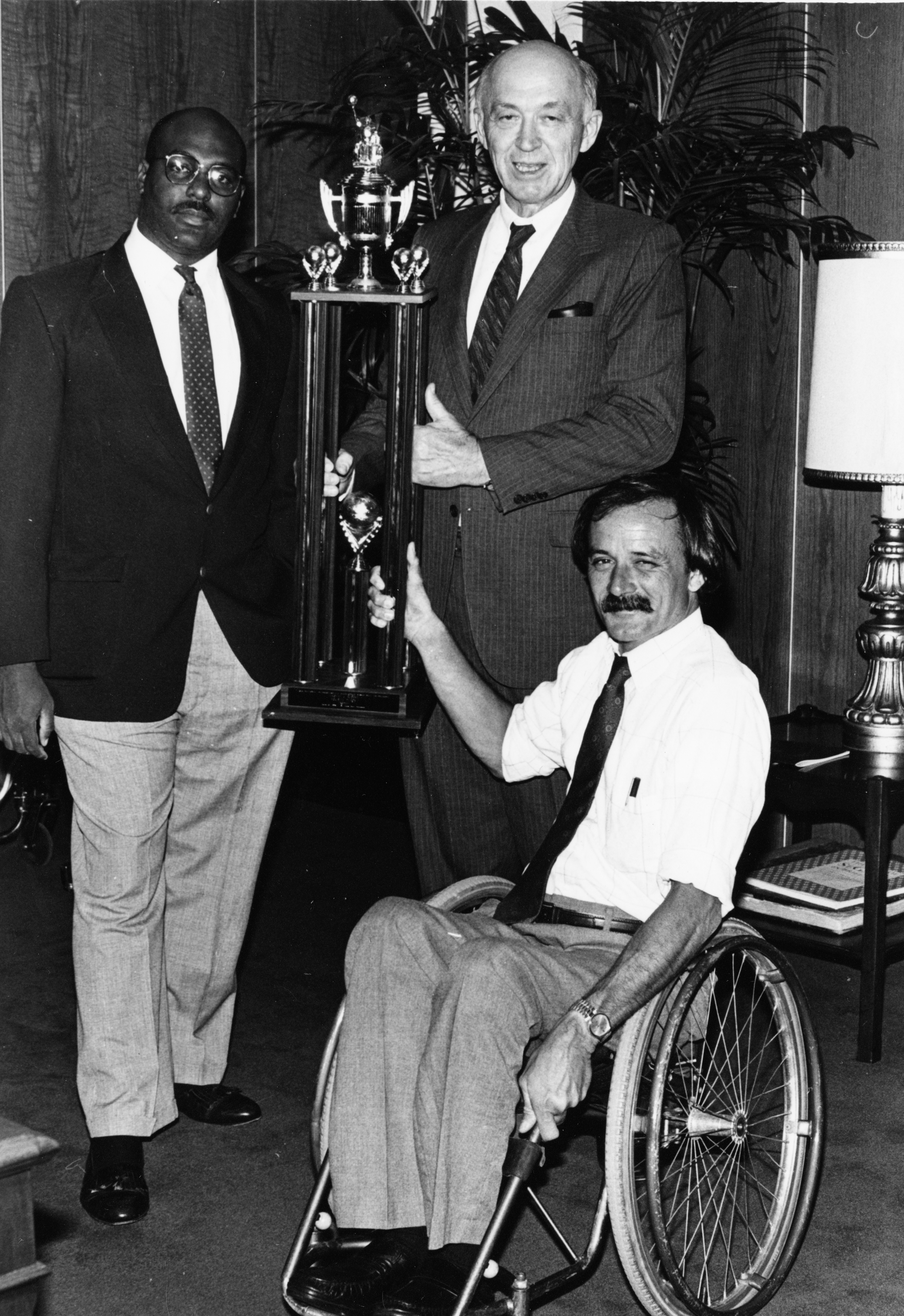 Photograph of Craig Williams, Dr. Wendell Nedderman and Jim Hayes holding a trophy