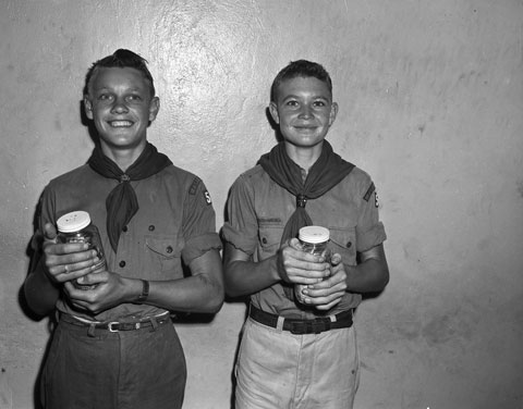 boy scouts holding collection jars