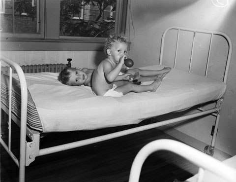 two infantile paralysis convalescents (polio) on a bed