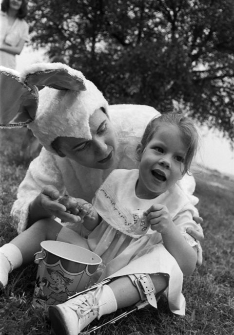 Child with cerebral palsy and an adult dressed in a bunny costume