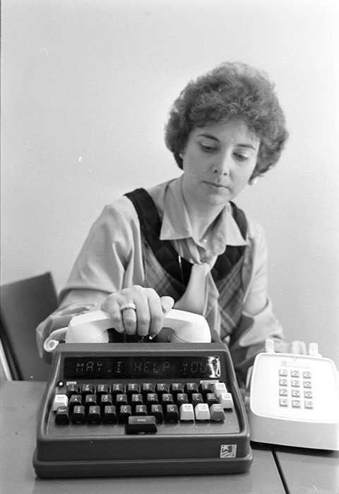 woman demostrating a TTY or a text telephone