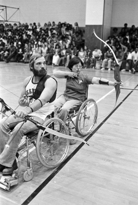 college students show athletic prowess with archery from their wheelchairs for high school students