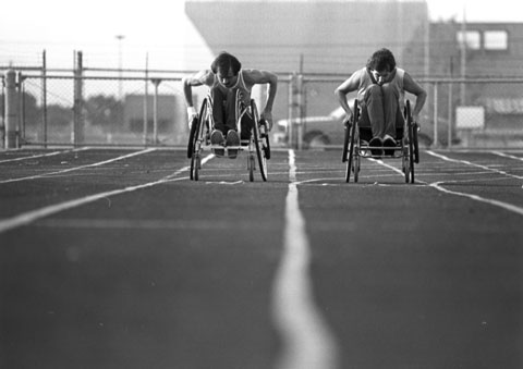 two men racing in wheelchairs