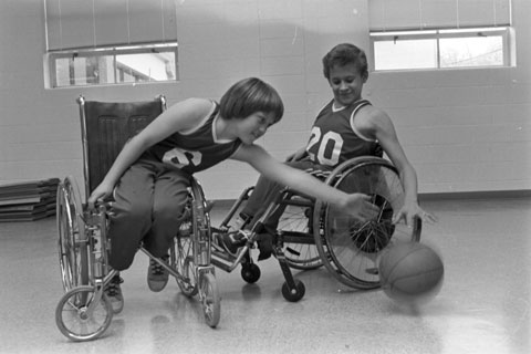 two boys play wheelchair basketball