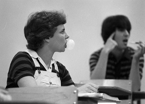 Hearing-impaired Kelly Ford blows bubble in class