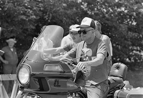 Malcolm Forbes, grand marshall for the "Texas Ride So Kids Can Walk" on motorcycle