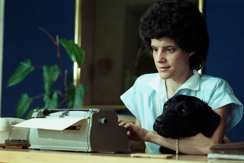 woman with her guide dog, working as receptionist