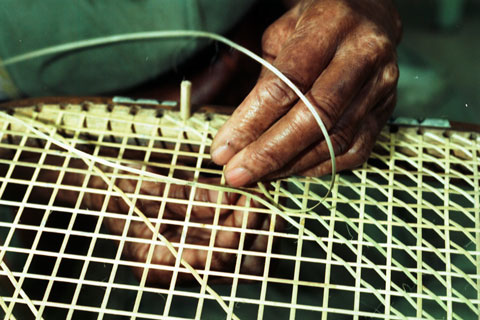 closeup of a person caning a chair