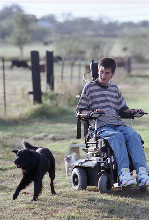 Todd Whitehead, paralyzed, enjoys an outing with his dog Crow
