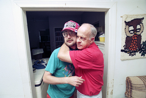 At HEADS UP House, Bret Dumas gets hug from co-founder George Bolden