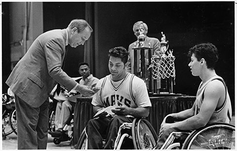 B.J. Skelton (left) presents award for Movin' Mavs winning national championship in wheelchair basketball; award