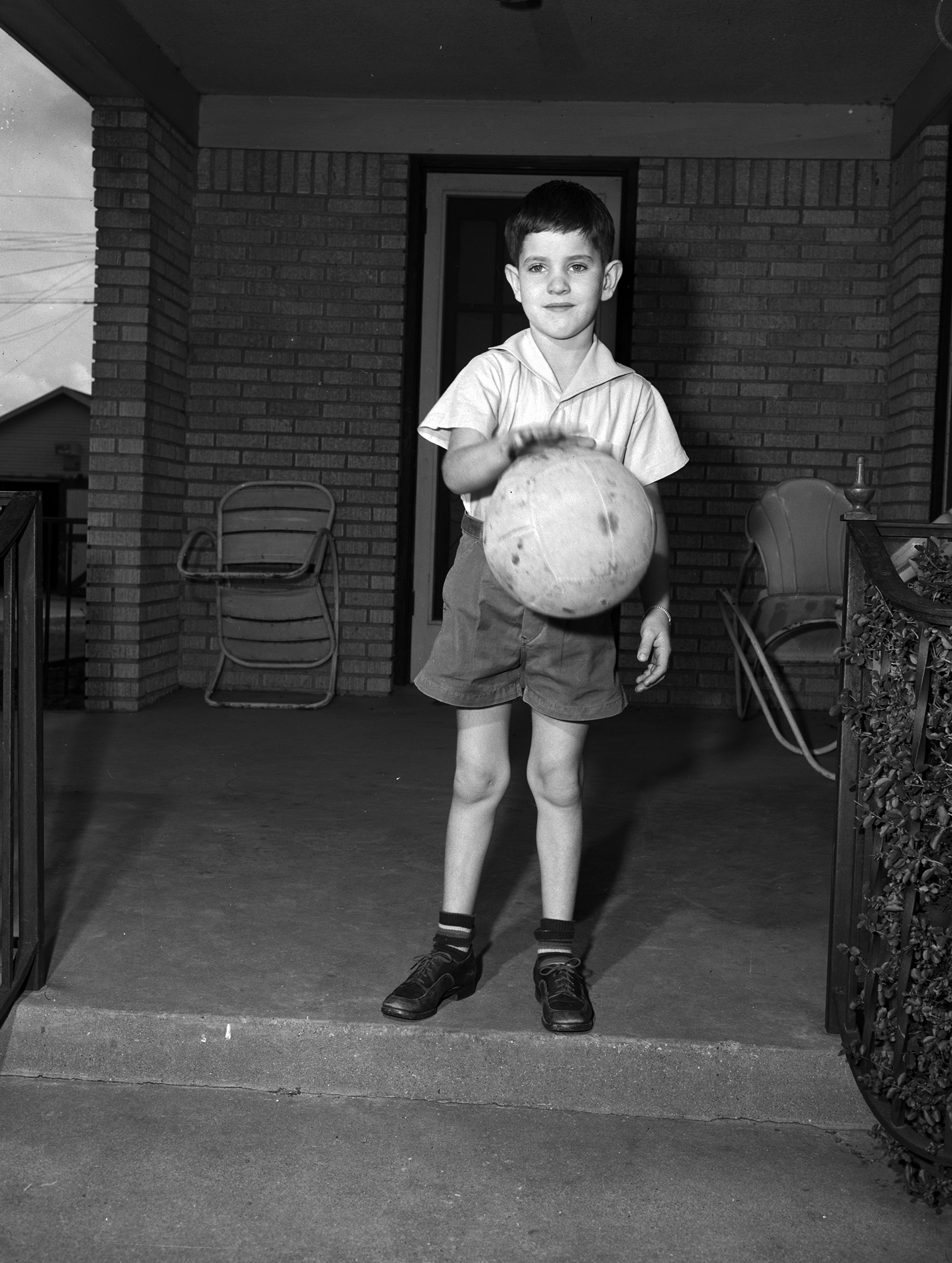 DIck Cantrell dribbling a ball on his front porch.