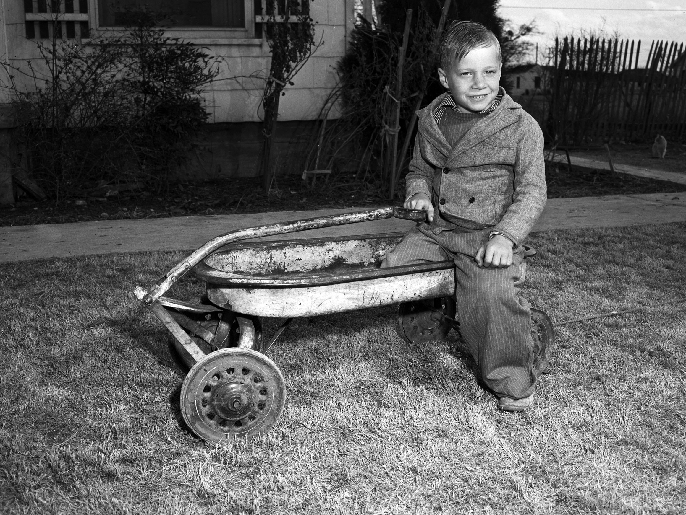 Gerry Tanner playing in a wagon.