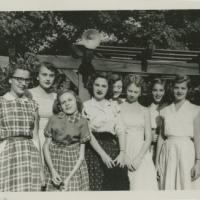 Shirley Sue Smith (third from left) and seven friends posing outdoors.