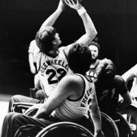 Two wheelchair basketball players during a game