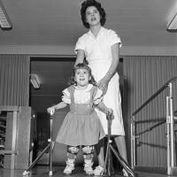 cerebral palsy patient assisted by a woman