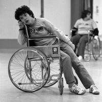 A woman sitting sideways in a wheelchair