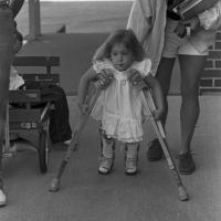 unidentified female child with crutches