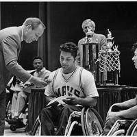 B.J. Skelton (left) presents award for Movin' Mavs winning national championship in wheelchair basketball; award
