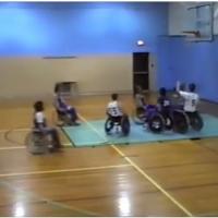 6 men in wheelchairs playing basketball