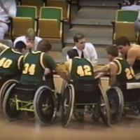 wheelchair basketball players in huddle with coaches