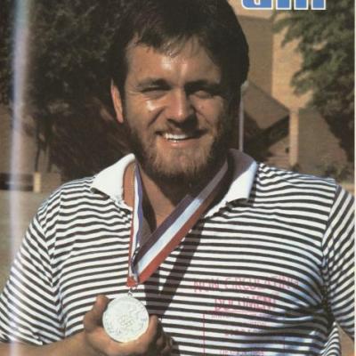 Randy Snow holding Olympic medal on the cover of the October 1984 UTA Magazine