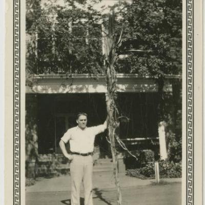 Frank Musick with sugar cane stalk at Rusk State Hospital