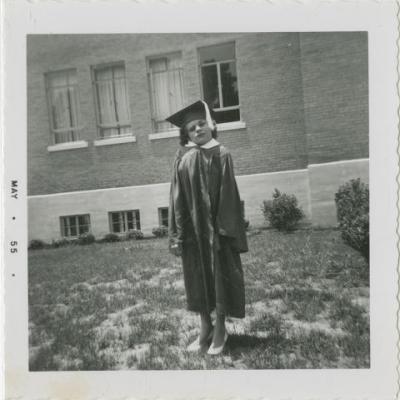 Shirley Sue Smith graduation photograph taken May 1955. She's wearing a cap and gown. This is from her high school graduation.