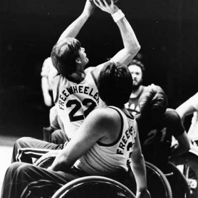 Two wheelchair basketball players during a game