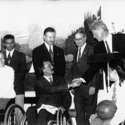 Jim Hayes shakes hands with President Bill Clinton; State Senator Mike Moncrief and U.S. Rep. Martin Frost are in background.