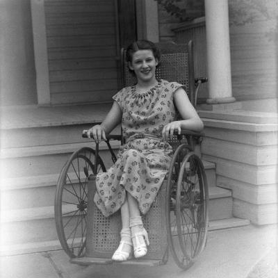 Polio patient Mary Elizabeth Runkles poses in her wheelchair during a Fort Worth visit from President Franklin D. Roosevelt