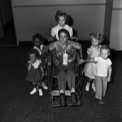 young polio patients, including one in a wheelchair, fundraising for a charitable organization