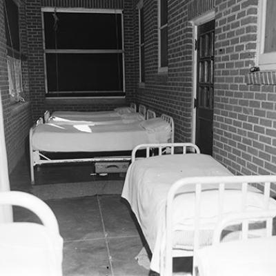 empty beds on porch at Abilene State Hospital