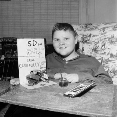 child with muscular dystrophy, showing poster he made