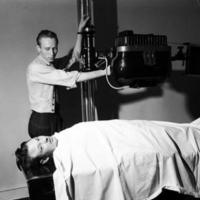 J. E. Martin lies on x-ray bed