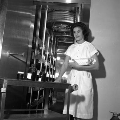 woman standing with a tray of bottles at Fort Worth Eye Bank