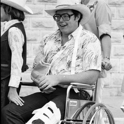 man in a wheelchair wearing a cowboy hat