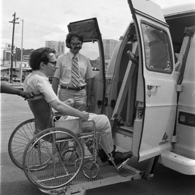 wheelchair bound man being raised into van