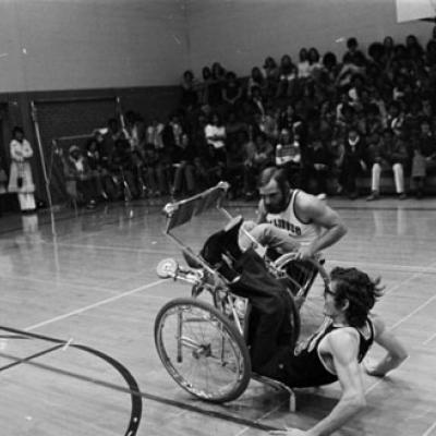 college students demonstrate wheelchair wrestling bout for high school students
