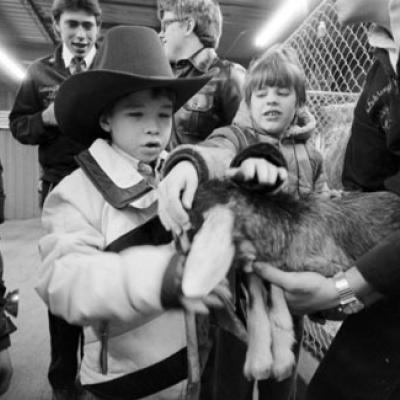 visually impaired children pet a goat