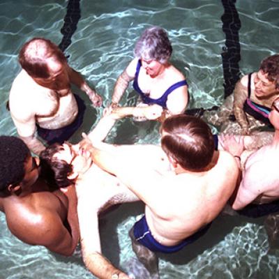 Dennis Robbins is assisted with his aquatic exercises in the Carter Rehabilitation Center pool