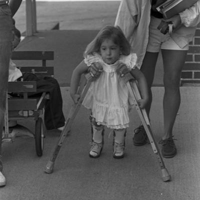 unidentified female child with crutches