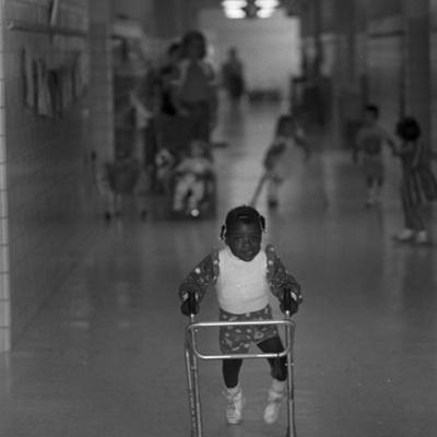 T'Erica White makes her way down the hall with a walker