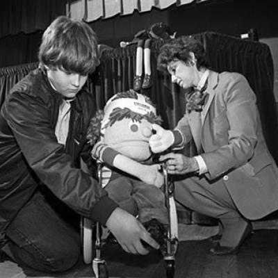Michael Duncan (left) and teacher Marta White with wheelchair puppet